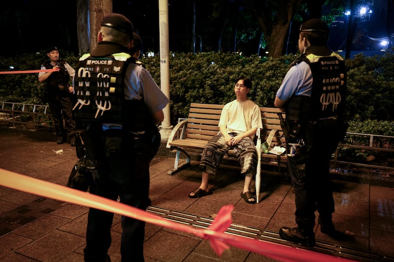 A man is surrounded by police at Victoria Park, during the 36th anniversary of the crackdown on pro-democracy demonstrators at Beijing's Tiananmen Square in 1989, in Hong Kong.