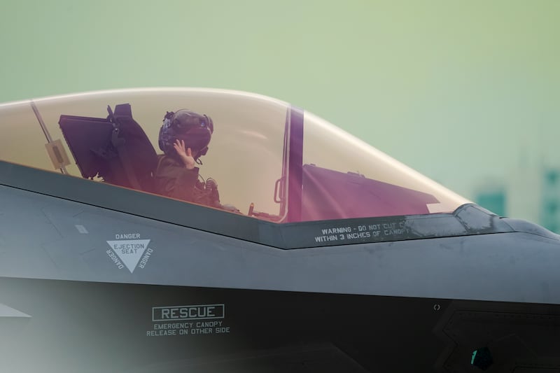 A U.S. Air Force demonstration team pilot waves to spectators before taking off Don Mueang airbase in Bangkok, March 7, 2025.