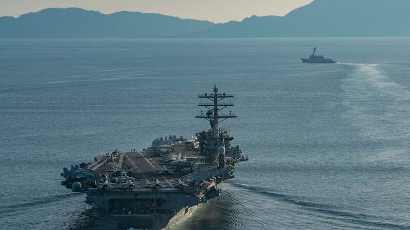 The aircraft carrier USS Nimitz and the guided-missile cruiser USS Princeton transit the Balabac Strait, which connects the South China Sea with the Sulu Sea in this July 15, 2020 photo. The Nimitz is currently on a military drill in the South China Sea.