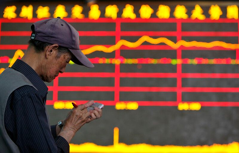 图为股民站在深圳成指信息板前;中国面临人口老龄化、政府债务、房地产金融危机等问题,股市再次大跌。 (路透社图片)