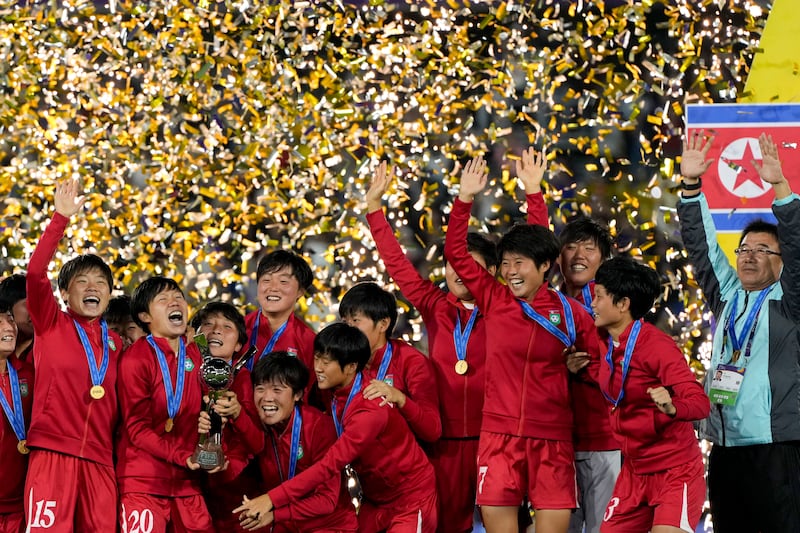 North Korean players celebrate with the trophy after winning the U-20 Women's World Cup final soccer match against Japan in Bogota, Colombia, Sept. 22, 2024.