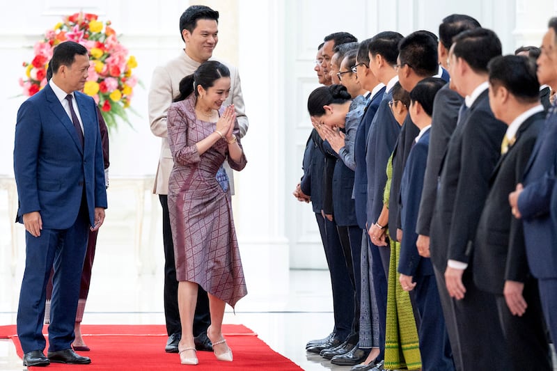 Thailand's Prime Minister Paetongtarn Shinawatra and her husband Pidok Sooksawas greet Cambodian government officials as Cambodia's Prime Minister Hun Manet looks on at the Peace Palace in Phnom Penh.