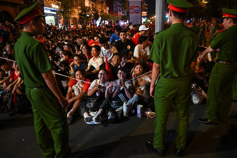 Spectators gather overnight in Ho Chi Minh City in the early hours of on April 30, 2025, ahead of a parade marking the 50th anniversary of the fall of Saigon and the end of the Vietnam War.