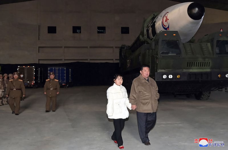This image released by the North Korean government and not independently verified shows North Korea's leader Kim Jong Un walking with his daughter Ju Ae as he inspects the intercontinental ballistic missile (ICBM) "Hwasong Gun 17" at Pyongyang International Airport, Nov. 18, 2022.