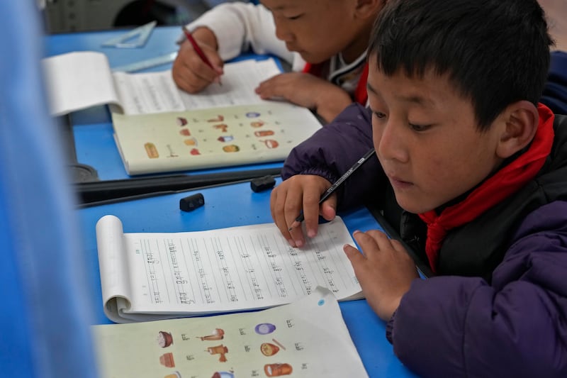 Tibetan students learn Tibetan writing in a first-grade class at the Shangri-La Key Boarding School during a media-organized tour in Dabpa county, Kardze Prefecture, Sichuan province, China on Sept. 5, 2023.